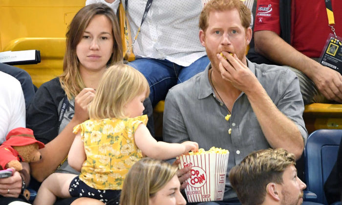TORONTO, ON - SEPTEMBER 27: Prince Harry with Hayley Henson, wife of British Paralympian Dave Henson and their two-year-old daughter Emily attend the Seated Volleyball on day 5 of the Invictus Games Toronto 2017 at Mattamy Athletic Centre on September 27, 2017 in Toronto, Canada. The Games use the power of sport to inspire recovery, support rehabilitation and generate a wider understanding and respect for the Armed Forces. (Photo by Karwai Tang/WireImage)